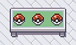 Une table pixellisée avec 3 pokéballs dessus