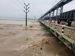 The rise of water level in the Koshi river. And people are watching from the bridge.