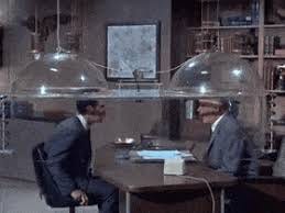 Maxwell Smart and the Chief of CONTROL sit down under the Cone of Silence