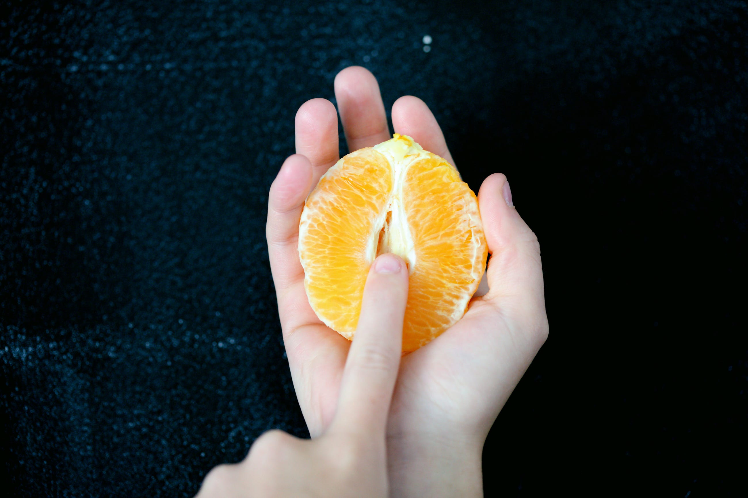 Eine Orange und ein Finger