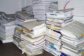 Stacks of notebooks piled high bundled up with string