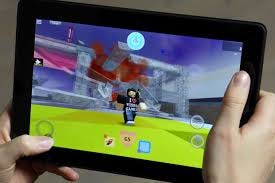 A person playing roblox on a tablet, with a roblox character in the middle