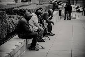 A group of people sit outside a garden.