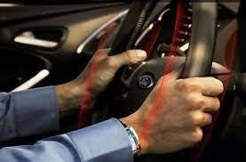 Image of a man holding a steering wheel that vibrates