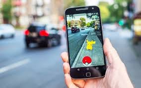 A person holding up a phone with an Augmented Reality Pikachu on Pokemon go