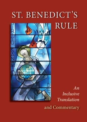 Cover of a recent reissue of The Rule of St. Benedict with image of stained glass window showing the saint holding a globe of the world illuminated by a single ray of light.