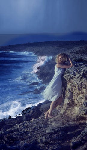 A woman on the shore in the midst of a storm.