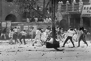 Stone-throwing by a mob in Chandni Chowk shopping centre, Old Delhi during riots between Hindus and Sikhs over the future of Punjab State in 1966.