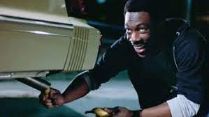 Eddie Murphy putting a banana in a tailpipe of a car