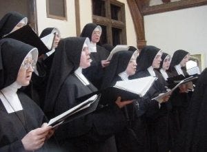 Groups of nuns singing in church