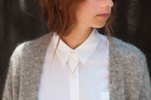 gabriela artigas small necklace on buttoned up white blouse
