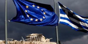 A European Union (EU) flag, left, and Greek national flag fly near the Parthenon temple on Acropolis hill in Athens, Greece, on Monday, Oct. 31, 2011. Europe's plan to solve the region's debt crisis made credit-default swaps covering Greece 