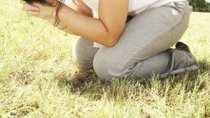 Kneeling in field Praying grass - 900