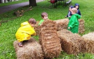Kids play with straw bales 