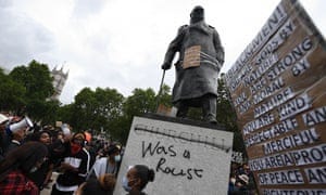 Statue of Churchill with graffiti that reads “Churchill Was a Racist”