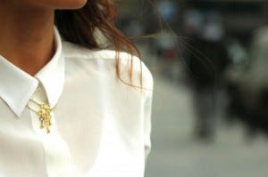 buttoned up white blouse with necklace on top