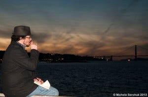 Gray writing while watching the San Francisco bay at sunset and smoking a cigar