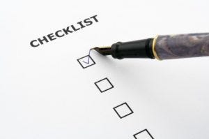 checklist with a ticked box and a pen