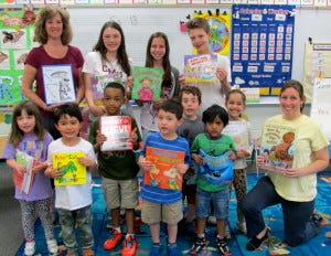 Nancy Elwell, top left, MMS Book Fair Co-Chair along with Kimberly Phillips (not pictured here), said, "We chose TBA to receive our extra funds from the book fairs because we wanted to keep it in the community, and we knew that the facility is brand new and might need some help." Leah Perlmutter, far right, Evesham Child Care Director, said, "Being a new center, these books really, really helped us. Books can be expensive, so we really appreciate it." The women pose with students from MMS and TBA.