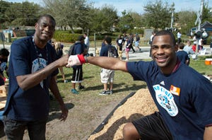 Special Olympics athlete Anthony Nunn (MN) works with NBA legend and longtime Special Olympics supporter Dikembe Mutombo at NBA Cares Day of Service in Orlando, FL