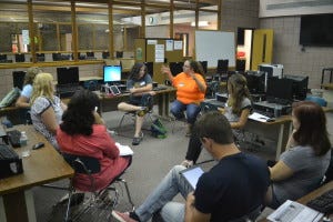 Leading a discussion on alternatives to paper and pencil tests is VMS special education teacher Julie Elliot, in orange, who also helped organize the day’s event. 