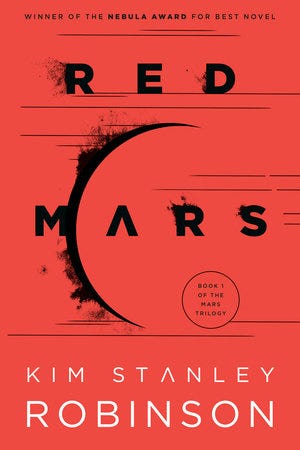 The cover of the paperback book called Red Mars, by Kim Stanley Robinson. It shows an outline of a planet, and the main color is red.