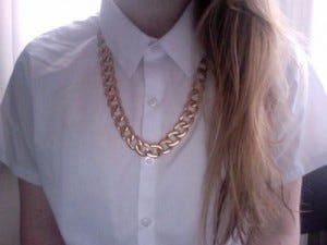 chunky necklace on buttoned up blouse
