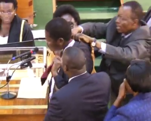 MP Ekanya attempts both suicide and undressing on the floor of Parliament, while endeavouring  to convince the Minister of Local Government for the award of district status to Tororo county.