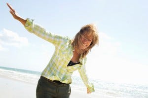 Mature woman playing in the beach