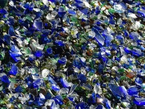 Tight closeup of a pit filled with colored glass shards — alt text