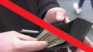 A man holding a wallet filled with cash, with a red line crossing out the image