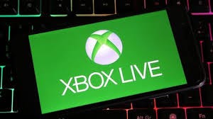 A mobile showing Xbox and keyboard on the background