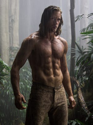 Still image from The Legend of Tarzan. Features a shirtless man in the rain.