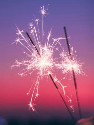 Sparklers with a sunset background.