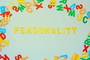 An image with alphabets scattered and the word Personality in the center of the image.