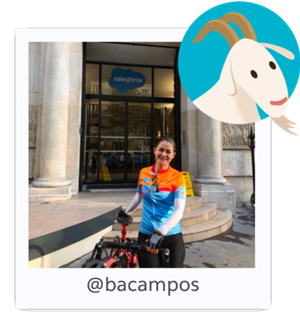 Photo of Trailhead Academy Instructor, Barbara Campos, with her bike outside Salesforce HQ. Cloudy is featured top right.