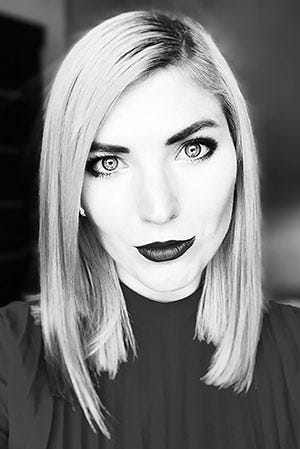 Zoe stares directly into the camera in this black and white professional photo