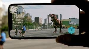A person holding up a phone displaying an augmented reality image of a T-rex in the city