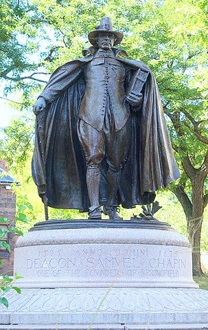 Bronze statue of a Puritan man walking forward