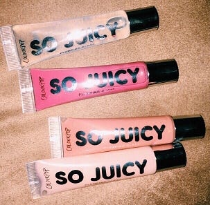 Four So Juicy lip glosses from Colourpop. The colors are clear, pink, tan, and a sparkly pink.