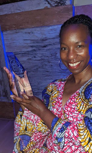 1966 brand representative accepting the Trophy for the Ready-To-Drink category for 1966: Artisanal Rum Punch at the 2022 International Spirits Challenge.