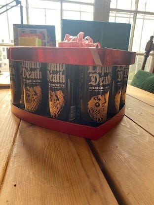 Liquid Death water cans in a red valentine’s day box.