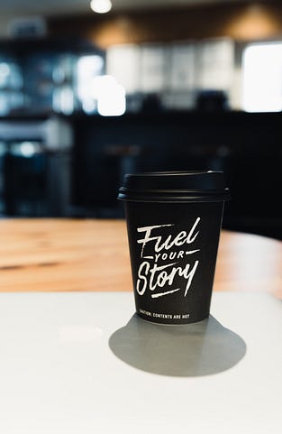 header photo of a coffee cup with great copywriting reminder to ‘fuel your story’