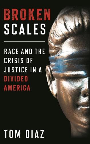 The cover of the book “Broken Scales: Race and the Crisis of Justice in a Divided America” is shown. The title is shown in red and white lettering over a black background. To the right of the title is the left half of a bronze  bust or statute of Lady Justice with a blue blindfold over her eyes.