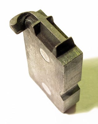 An overhanging f metal letter via James Mosley’s blog entry on “Type held in the hand”