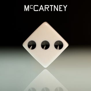 Paul McCartney “Paul McCartney III” single cover art; white diamond with three holes on black top to white bottom gradient background, “McCARTNEY” text on top