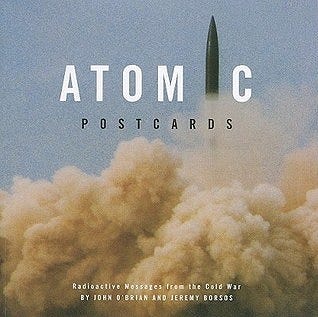 The cover of a book called Atomic Postcards, with a missile forming the letter “I” in the title.