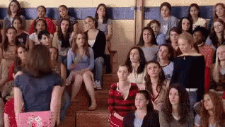 Mean Girls scene where everyone raises their hand after Tina Fey asks, “Who here has felt personally victimized by Regina George?”