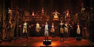 The company of Hamilton performing The World Turned Upside-Down