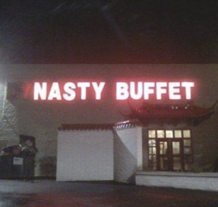 A sign for Dynasty Buffet that has some letters without light so it reads Nasty Buffet instead.